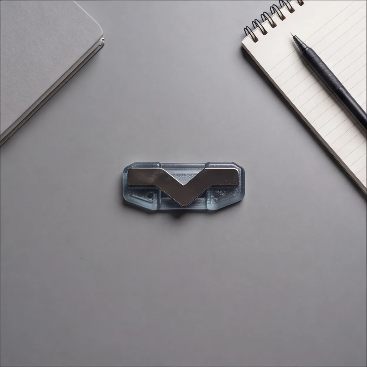 A StefMag resting on a desk beside a notebook and pen.