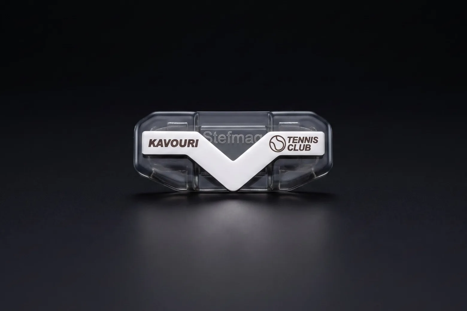 A StefMag with its polished steel V engraved for the Kavouri Tennis Club: the club name and a tennis ball logo.